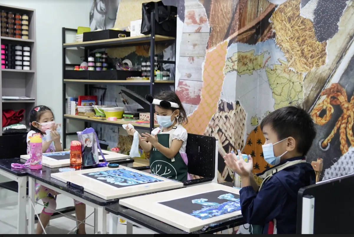 Children creating artwork together in an OpenKids art studio