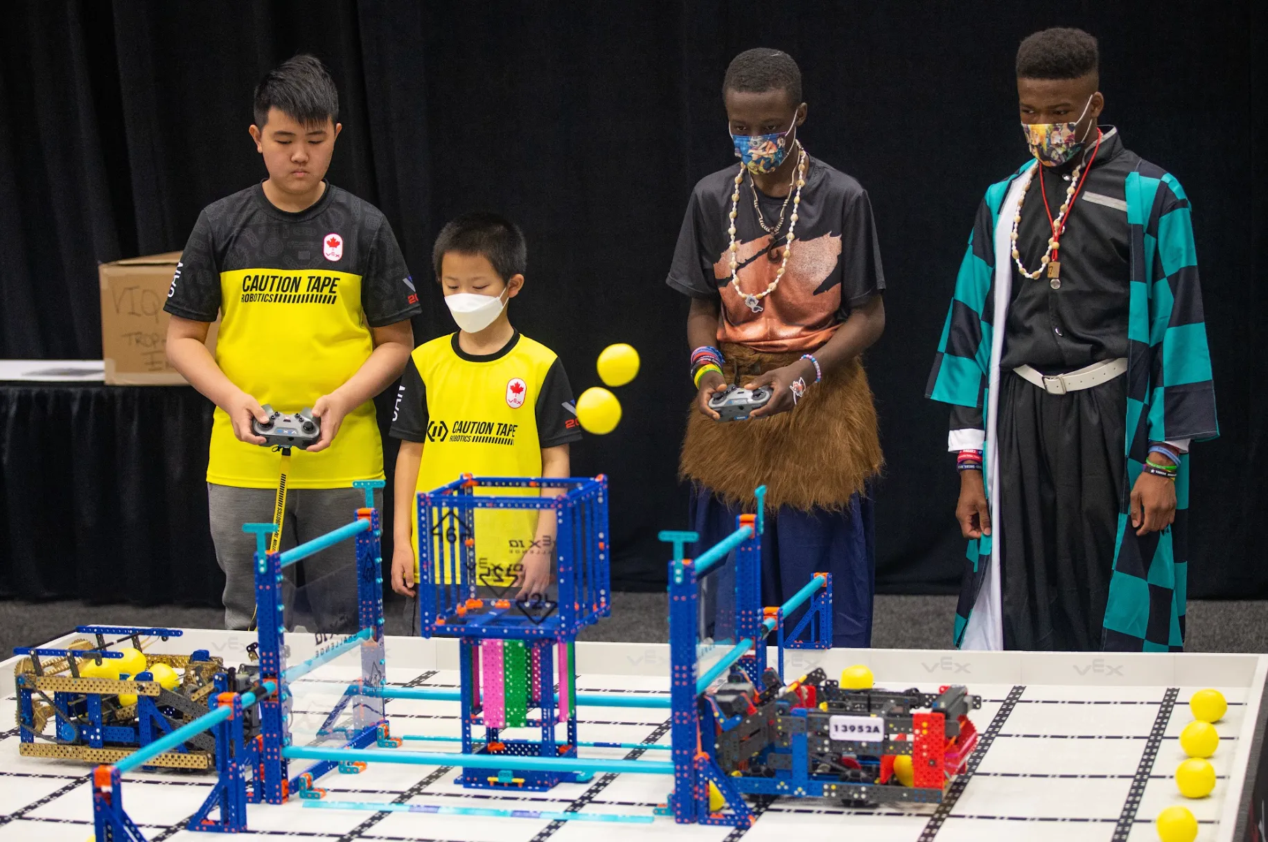Students driving competition robots at a VEX event