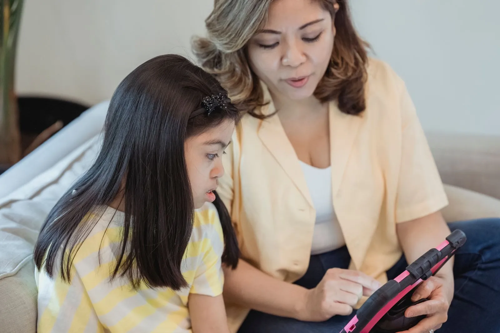 A parent and child reviewing a MagiBox learning record together on a tablet