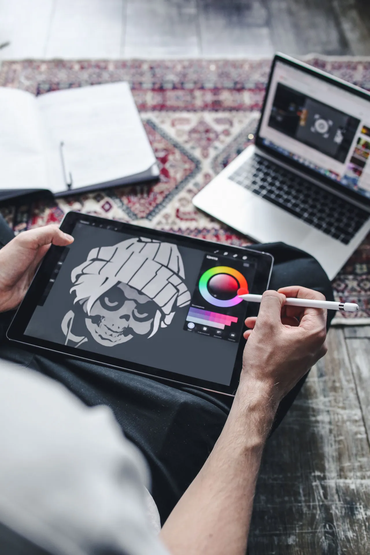 A student refining a digital illustration on a tablet for her portfolio